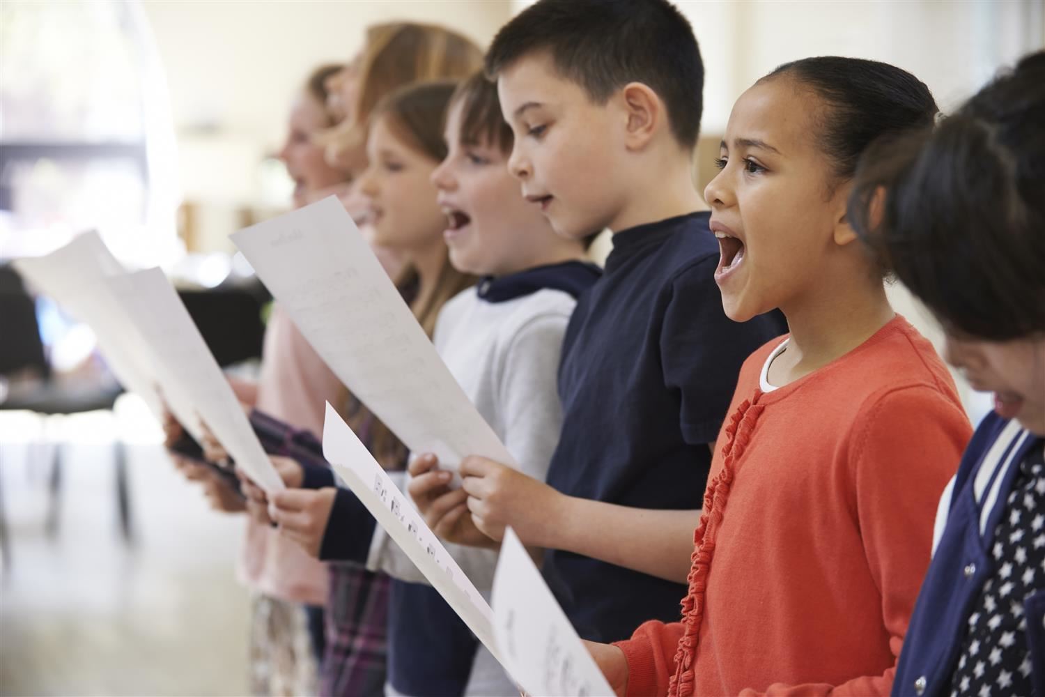 photo of students singing holding sheet music